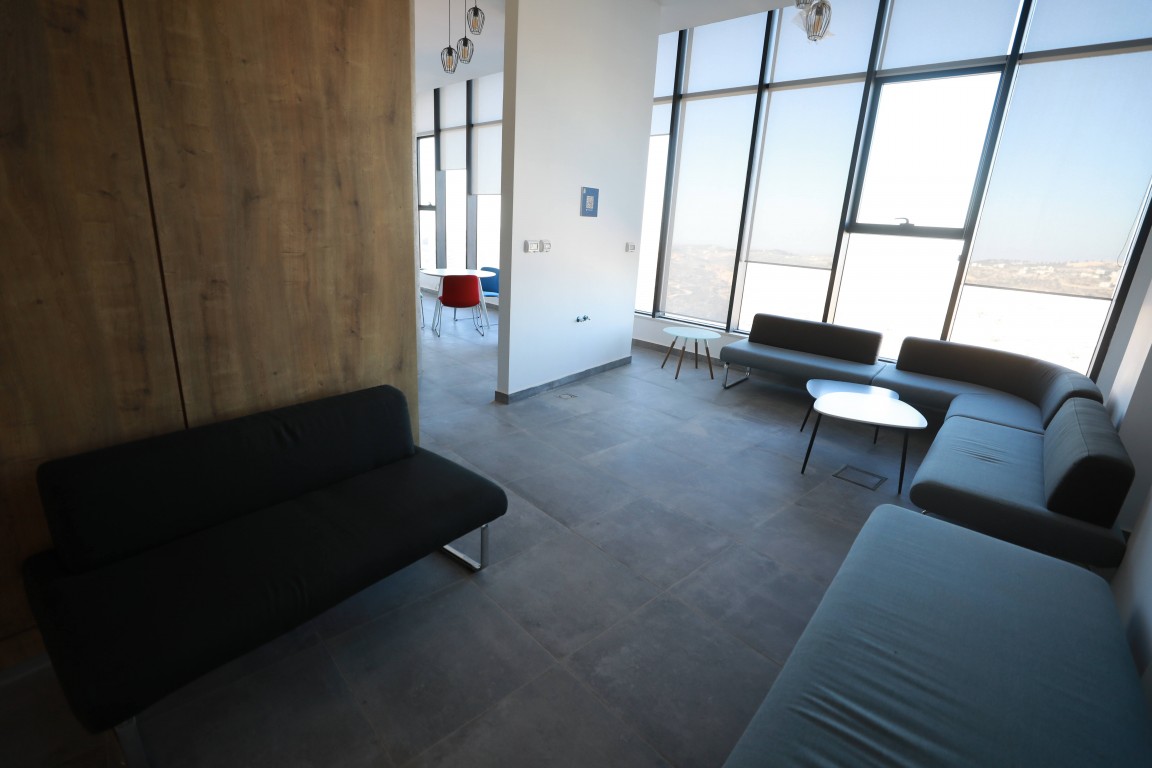 A corporate meeting room on an upper floor, with a full-height window onto the valley