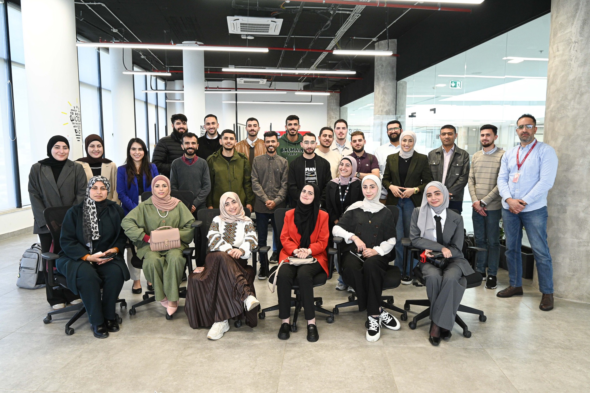 A large group of members and staff photographed together in the atrium