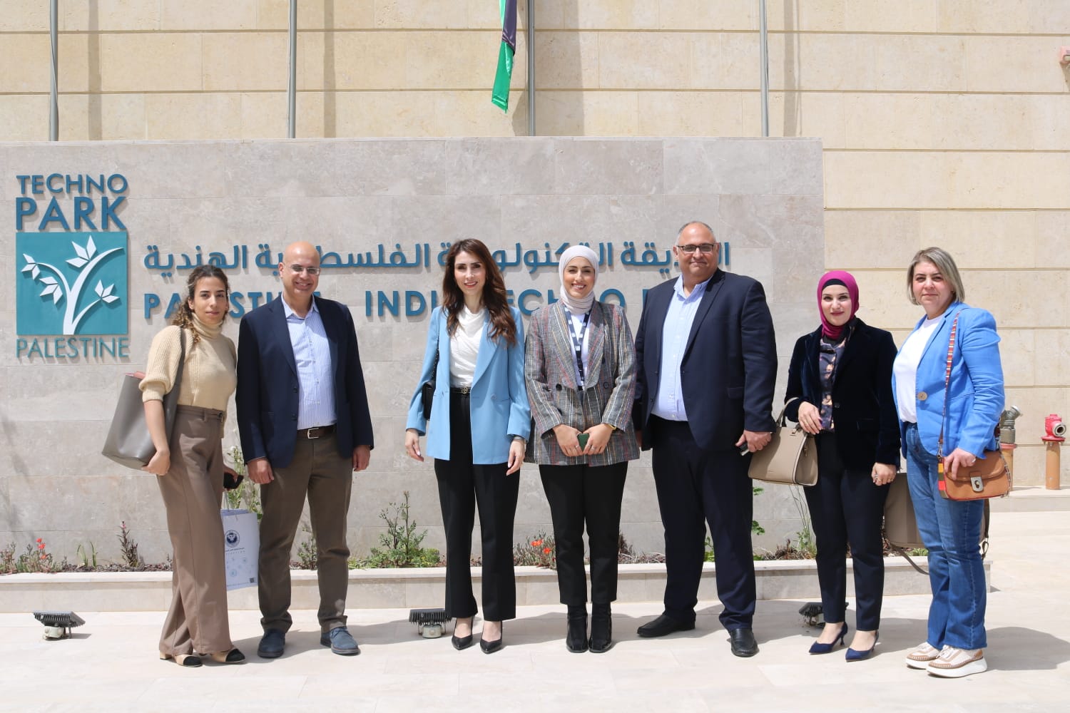A group photograph on the steps inside the building