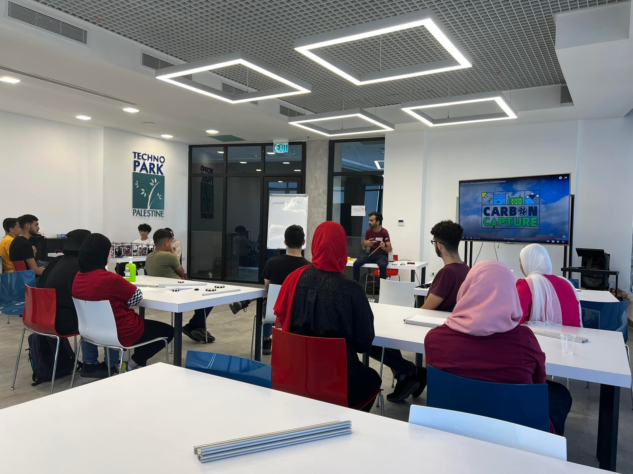 A session in the training room, with the group seated around long tables